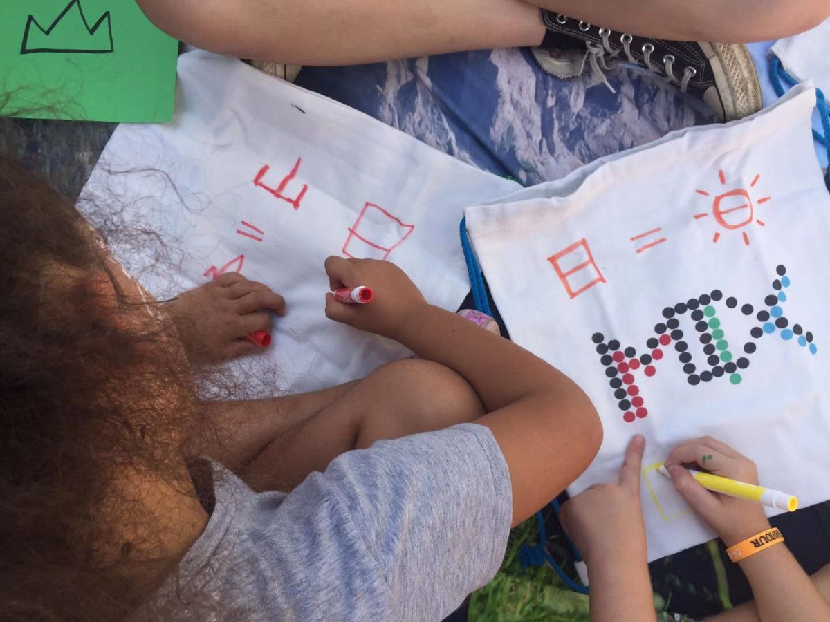 Children writing Chinese characters on MIX tote bags at the ASM picnic