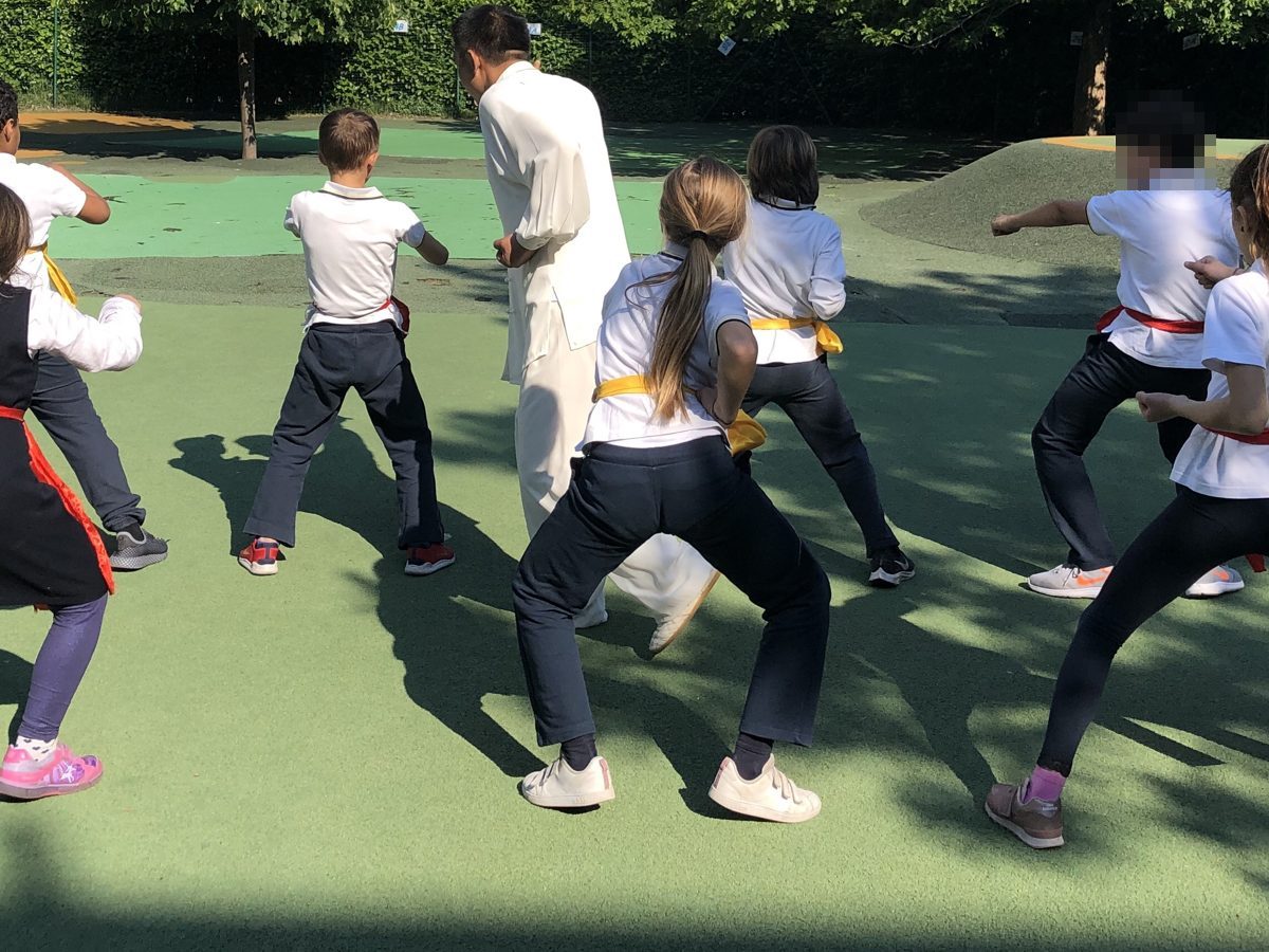Children practising kung fu in the schoolyard during a MIX demo at BES