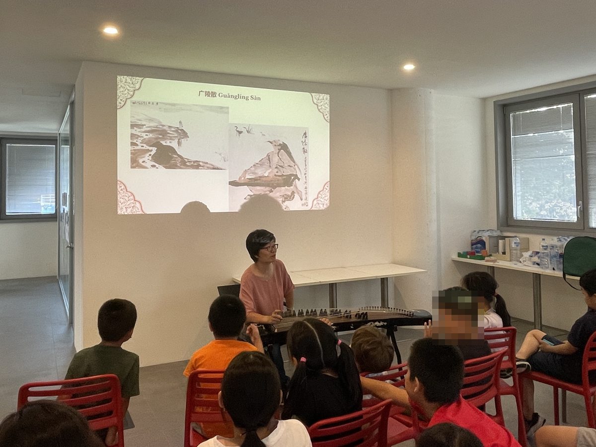 Children listening to a guzheng performance at the MIX Summer Camp 2022