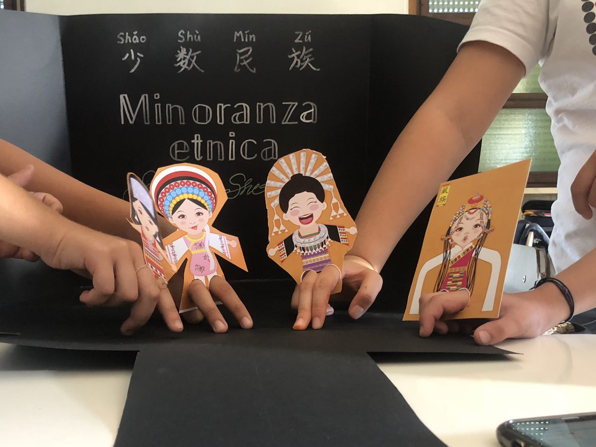 Children’s hands with finger puppets of China’s ethnic minorities at the Leone XIII summer camp 2019