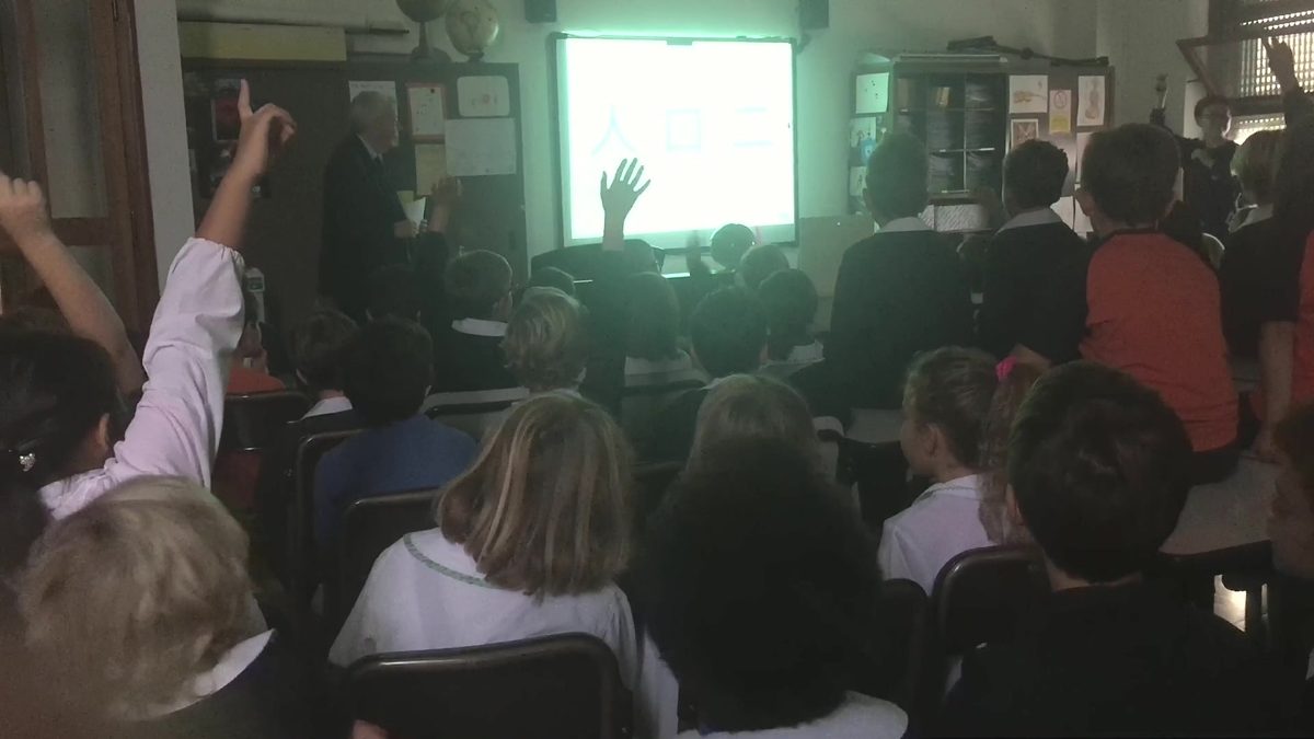 Students raising their hands during a MIX demo class at Leone XIII